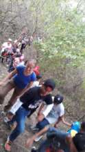 Families walking in nature reserve with guide