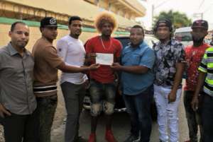 Mr. Felix giving a check