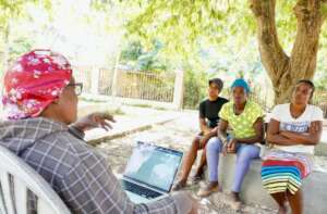 Freda meets with past graduates for an update.