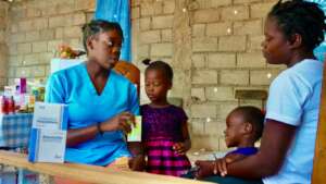 The program nurse sees a mom and her children.