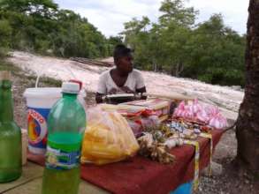 A woman sets up her small shop to sell goods.