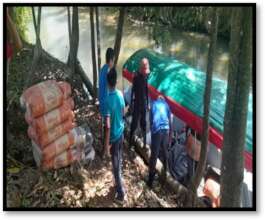 Oswin delivering materials for community oven