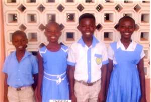 4 kids outside school in Ghana