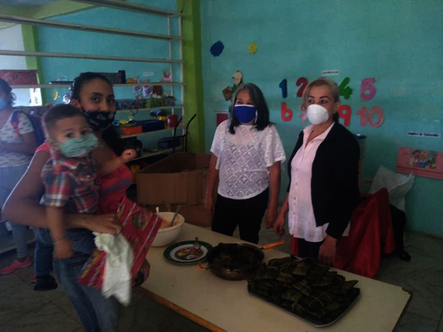 Mom and child receiving meal at christmas event