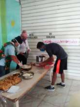 Another parent picking up food for his child