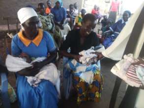 Newborn twins in Rose's community receive clothes.
