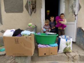 Receiving food, clothes and toys for the children