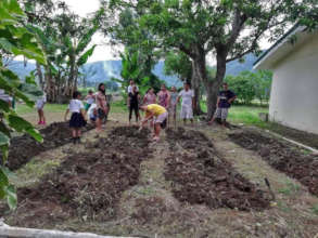 Parents preparing the garden plot.