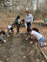 Students prepping a bed for a fall garden