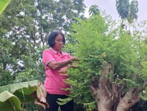 Khun Waan tending to the garden.