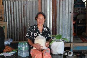 A lady in the slum receives her plant