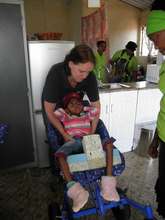 Bophelong beneficiaries receiving wheelchairs.