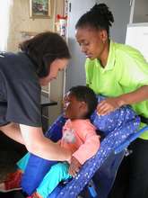 Bophelong beneficiaries receiving wheelchairs.