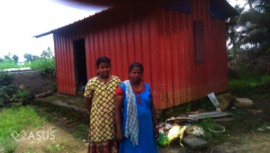 Maya with her mother in front of their house