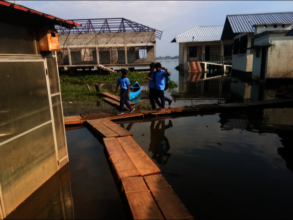 Children use a make-shift bridge made of benches