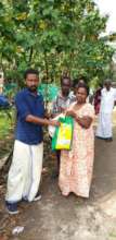 Poor woman in kerala receiving relief material