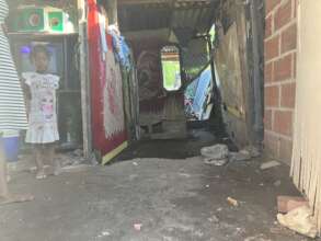 Deiner's Sister in their Home with Dirt Floor