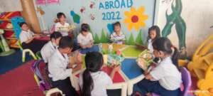 They enjoy reading at school together classmates