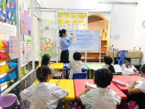 Pisey is teaching young kids at the SCC School
