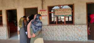 People waiting to get their vaccines outside camp