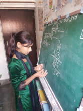 A young girl showing her math skills