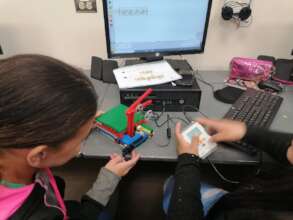 Young women programming their robot