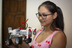 Young woman training in robotics