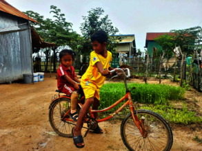 Riding a bike with her cousin