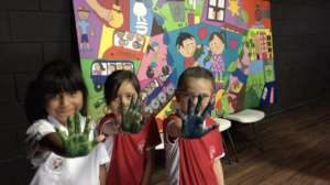 kids showing hands after signing peace with Earth