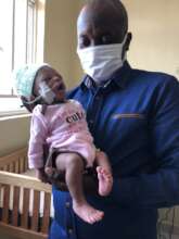 The baby with one of the Wellness Clinic staff