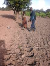 CTD agronomist helps woman prep land for planting