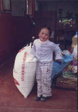 A Wawacha's child near to a sack of sugar