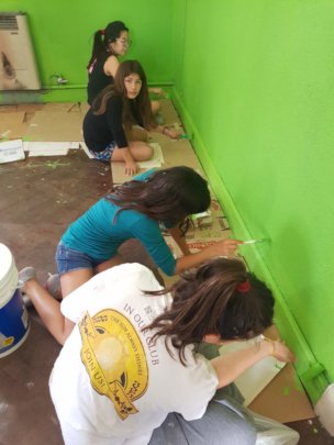 Girls and volunteers painting their bedrooms