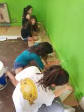 Girls and volunteers painting their bedrooms