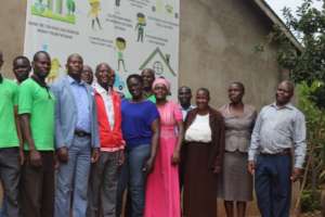 Some teachers pose near My Money banner