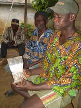 Farmer holding packet of Moringa oleifera seeds