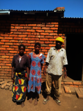 Esnart at her home with her family