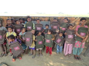Munni (right) and her peers get school supplies