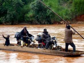 Volunteers crossing river to Kabri village