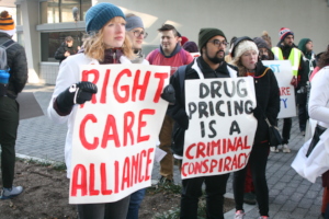 Activists at Eli Lilly protest with signs