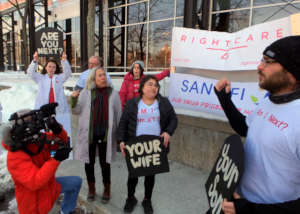 RCA activists protesting outside of Sanofi