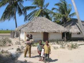 Abdul and his siblings in front of their hut