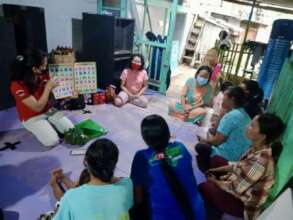 CF staff teaching a literacy class to women