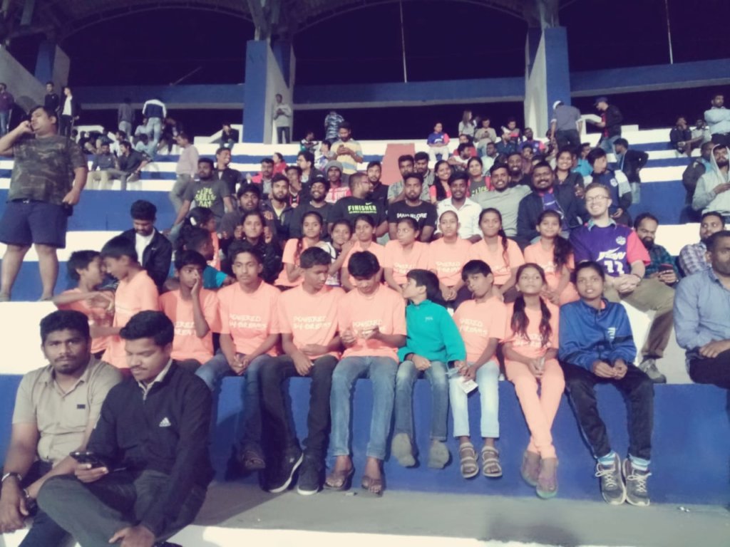 Young people watching a football match live