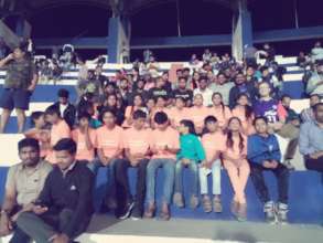 Young people watching a football match live
