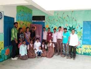 Painting the wall of their school by young people