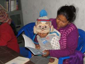 Champa Thami & child reading a book at Babare CLC