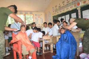 Boys receiving haircuts