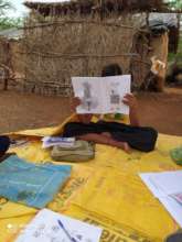A child reading our bi-monthly magazine (Morange)