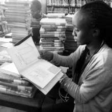Yvette cataloguing books at the Kaloleni branch